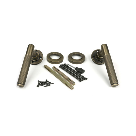 Brompton Sprung Lever Door Handle on Round Rose Set - Burnished Brass