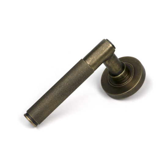 Brompton Sprung Lever Door Handle on Round Rose Set - Burnished Brass