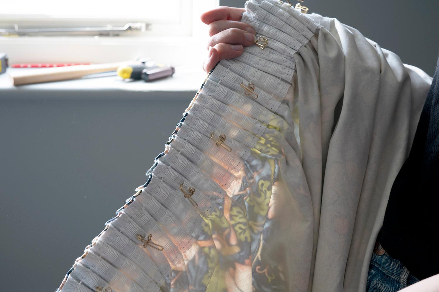 Underside of pleated curtains with hooks attached