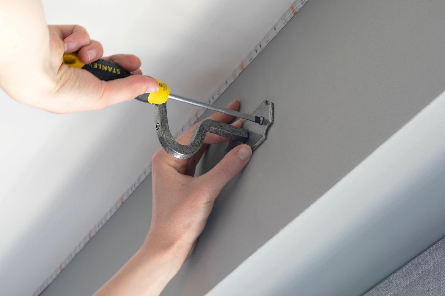 Fitting a pewter curtain mounting bracket