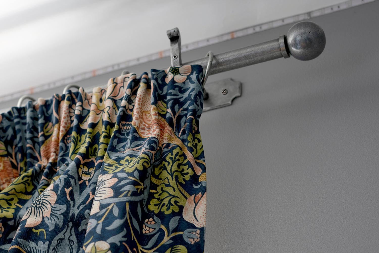 Pleated curtains hung using pewter curtain hardware