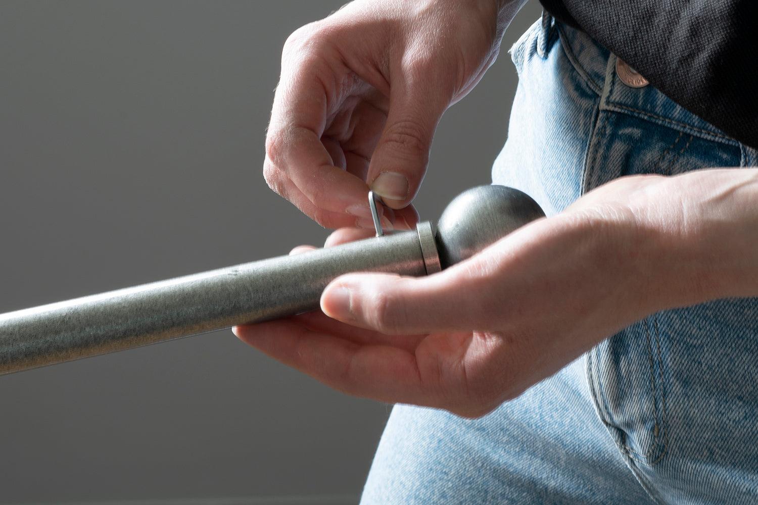 Securing a pewter ball finial to a curtain pole with a grub screw
