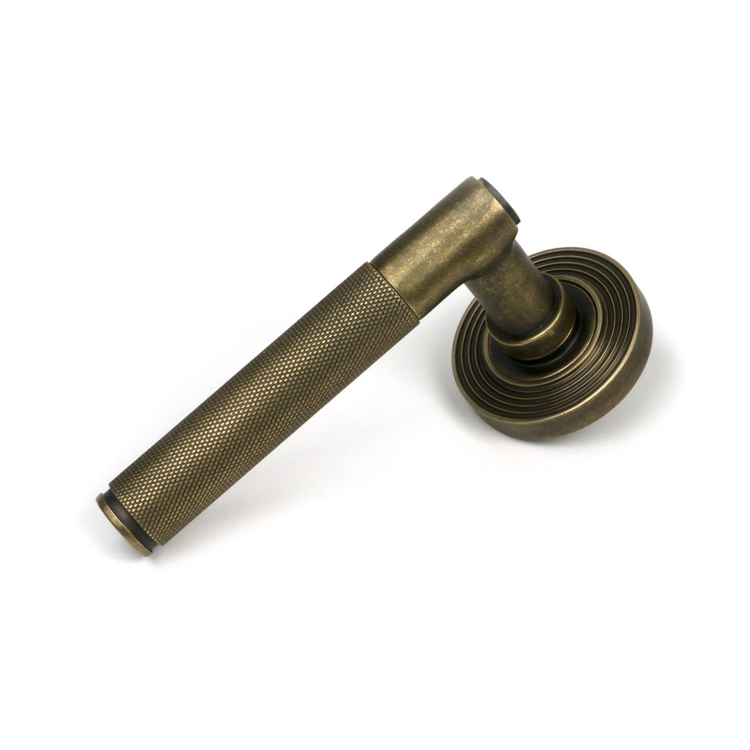 Brompton Unsprung Lever Door Handle on Beehive Rose Set - Burnished Brass