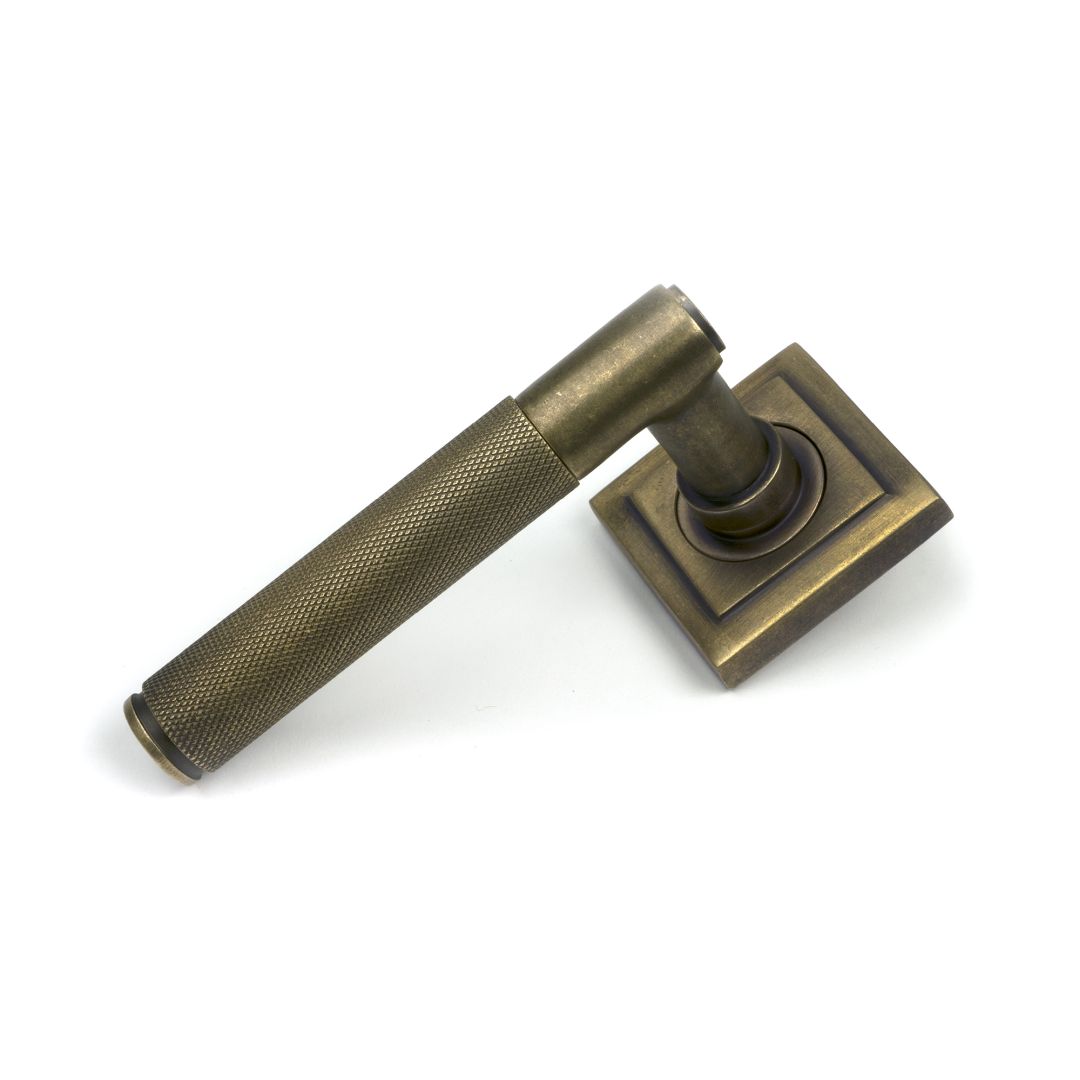 Brompton Unsprung Lever Door Handle on Square Rose Set - Burnished Brass
